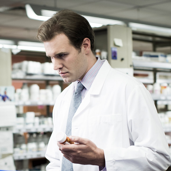 Pharmacist looking up a medication.